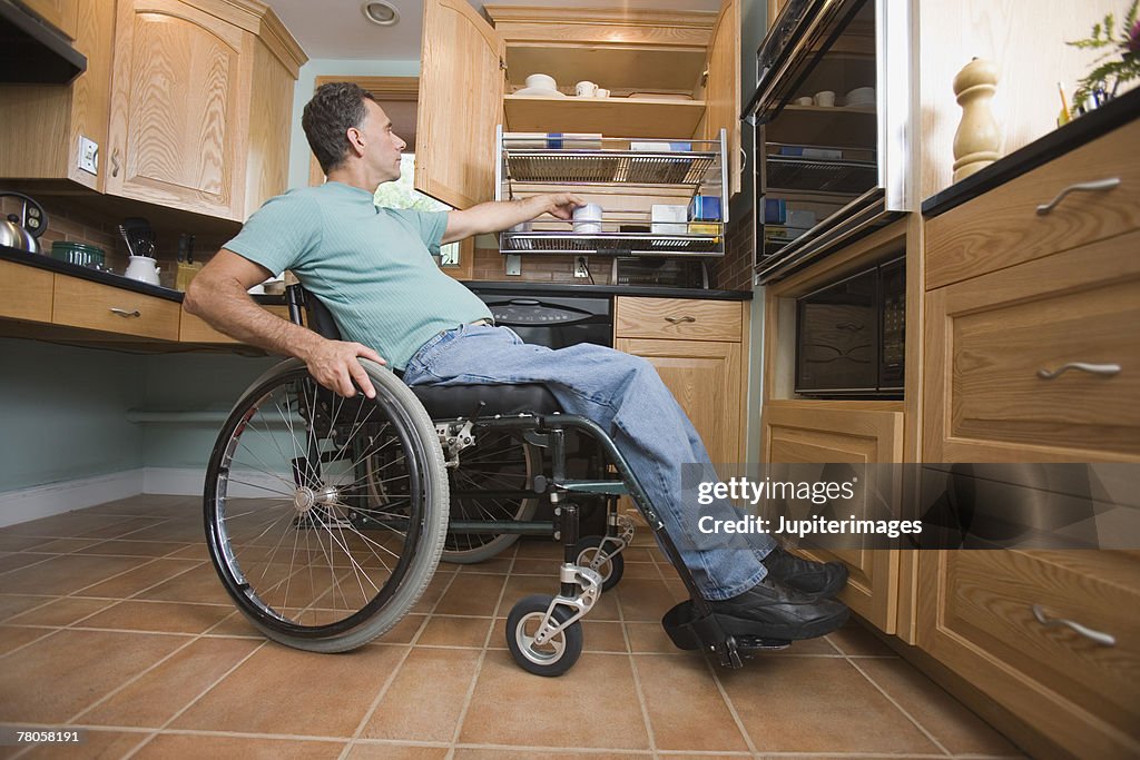 Man using wheelchair in kitchen