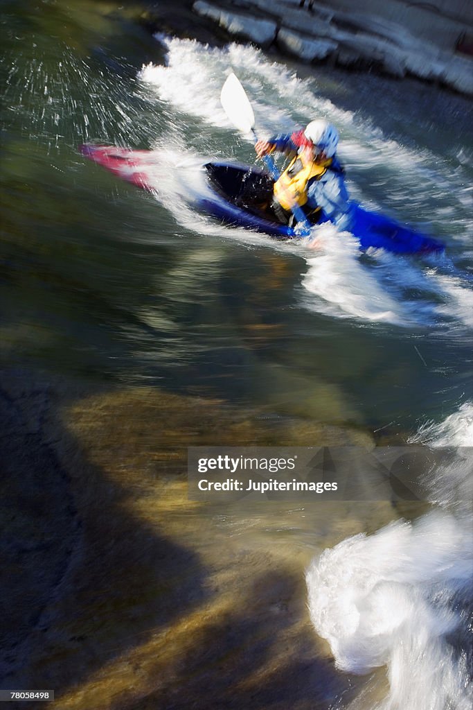 Person whitewater rafting