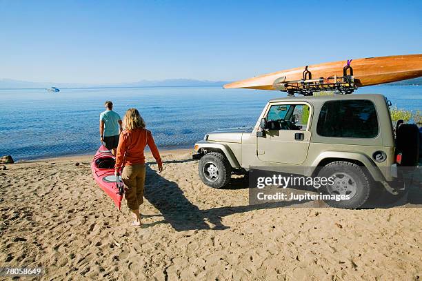 kayakers on a beach - kayaking beach stock pictures, royalty-free photos & images