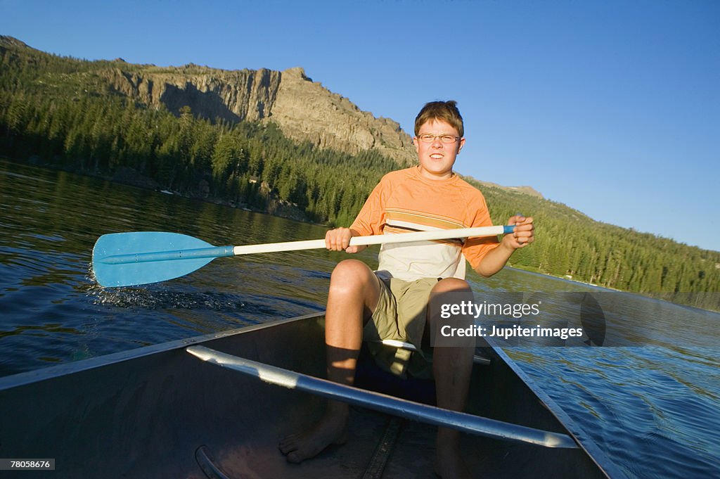 Teenage boy canoeing
