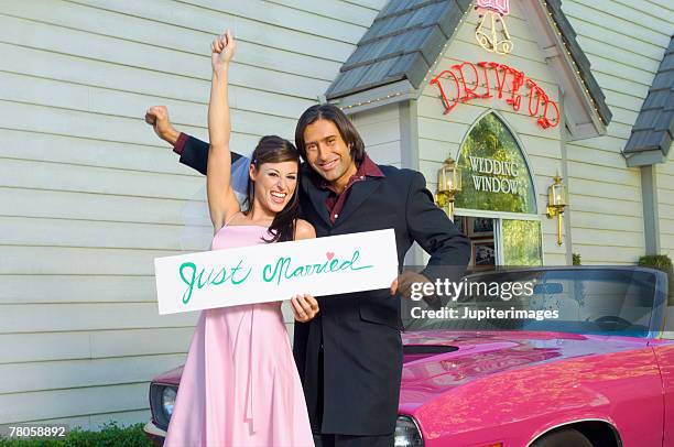 bride and groom holding sign - las vegas wedding stock pictures, royalty-free photos & images