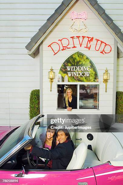 bride and groom by drive-up wedding chapel - las vegas wedding stock pictures, royalty-free photos & images