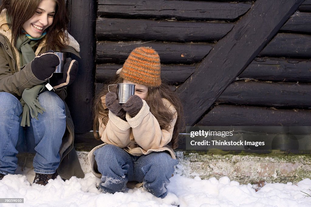 Mother and daughter with drinks