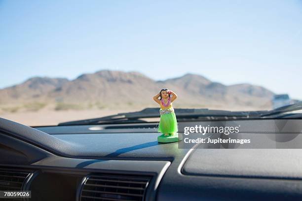 hula doll on car dashboard - car decoration stock pictures, royalty-free photos & images