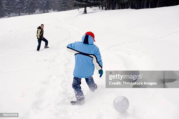 father and child playing in snow - mid winter ball imagens e fotografias de stock