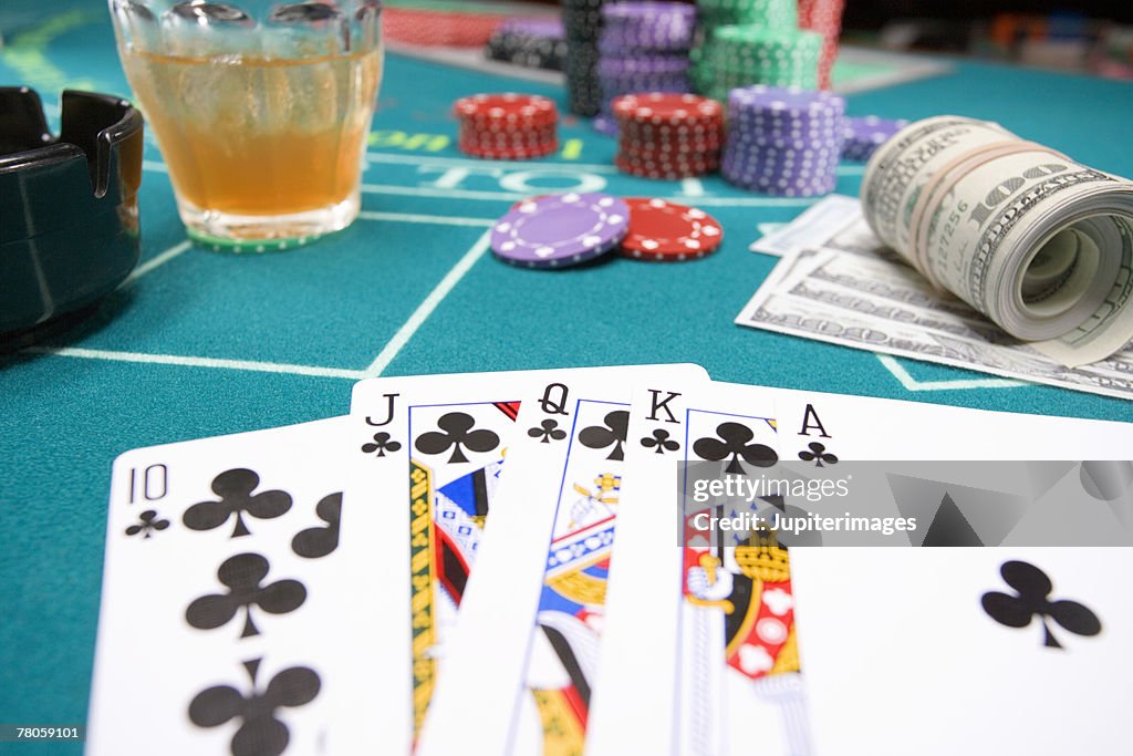 Royal flush and poker chips on gambling table