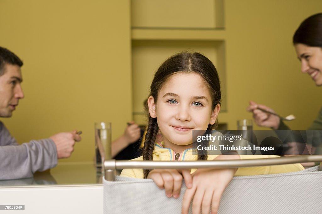 Smiling girl sitting at table