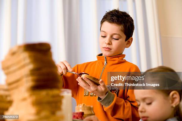 boy and girl preparing sandwiches together - marmalade stock pictures, royalty-free photos & images