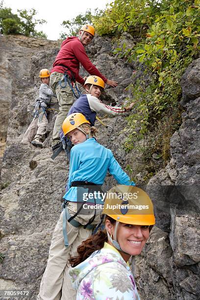 family rock climbing - boy rock climbing stock-fotos und bilder