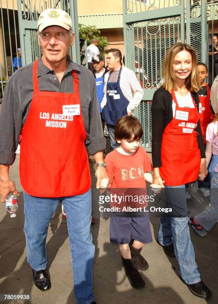 Actor Harrison Ford and actress Calista Flockhart with son Liam participate in serving Thanksgiving dinner to the Skid Row homeless at the Los...