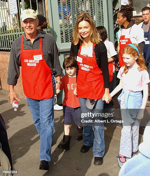 Actor Harrison Ford and actress Calista Flockhart with son Liam participate in serving Thanksgiving dinner to the Skid Row homeless at the Los...