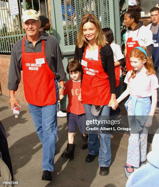 Actor Harrison Ford and actress Calista Flockhart with son Liam participate in serving Thanksgiving dinner to the Skid Row homeless at the Los...