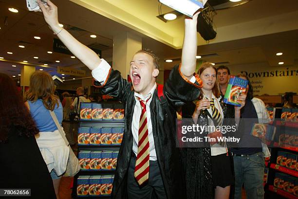 Fans with their books, among the first in a huge queue of people who were waiting to buy the 6th book in the Harry Potter series, Harry Potter and...