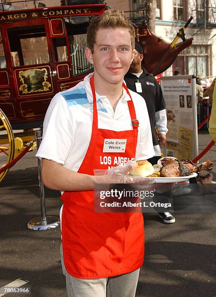 Actor Cole Evan Weiss participates in serving Thanksgiving dinner to the Skid Row homeless hosted by Kirk and Anne Douglas at the Los Angeles Mission...