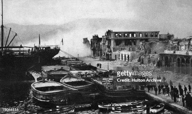 Ruined buildings on the quay at Smyrna are dynamited, following their partial destruction in the recent fire, 1922. The fire marked the end of the...
