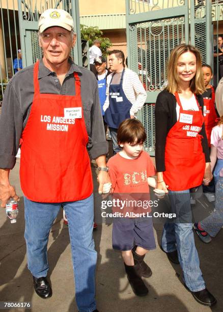 Actor Harrison Ford and actress Calista Flockhart with son Liam participate in serving Thanksgiving dinner to the Skid Row homeless at the Los...