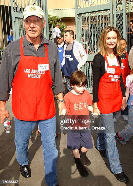 Actor Harrison Ford and actress Calista Flockhart with son Liam participate in serving Thanksgiving dinner to the Skid Row homeless at the Los...