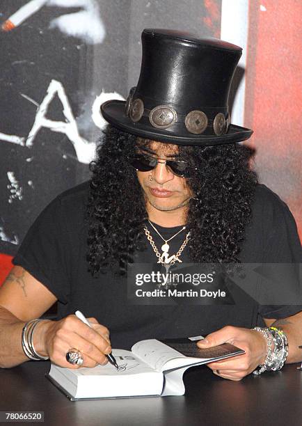 Saul Hudson, also known as 'Slash' former lead guitarist of US band 'Guns N' Roses' and current lead guitarist of the band 'Velvet Revolver,' signs...