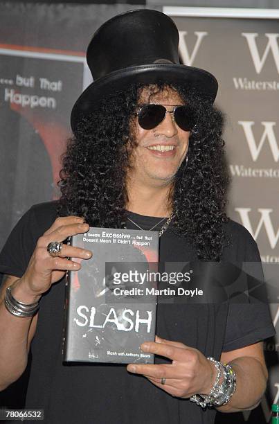 Saul Hudson, also known as 'Slash' former lead guitarist of US band 'Guns N' Roses' and current lead guitarist of the band 'Velvet Revolver,' signs...