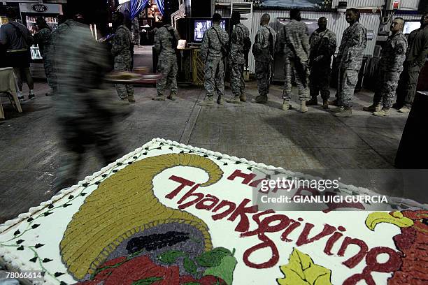 Soldiers line up to receive their piece of turkey during Thanksgiving celebrations in Warhorse US army base in Baquba, northeastern Baghdad, 22...