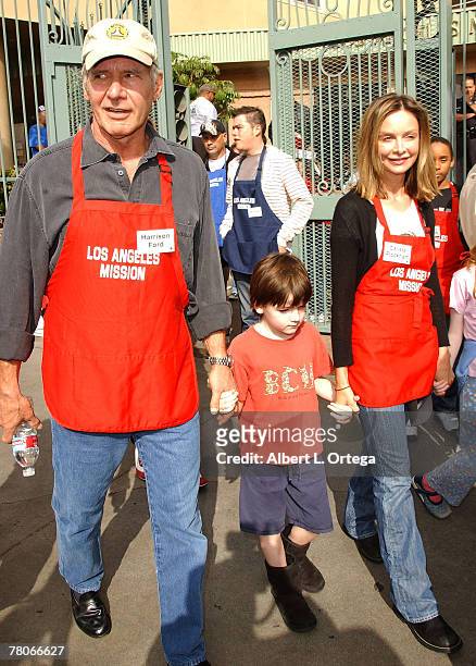 Actor Harrison Ford and actress Calista Flockhart with son Liam participate in serving Thanksgiving dinner to the Skid Row homeless at the Los...