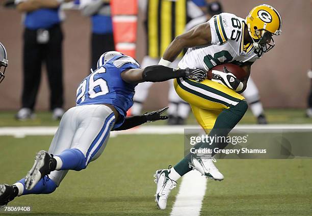 Greg Jennings of the Green Bay Packers scores a second quarter touchdown past Kenoy Kennedy of the Detroit Lions on November 22, 2007 at Ford Field...