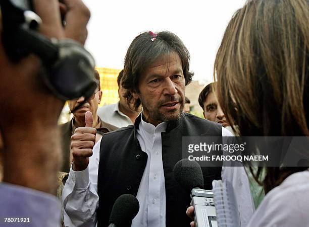 Pakistani cricketer turned politician Imran Khan talks with media representatives following his release from jail, in Islamabad, 22 November 2007....