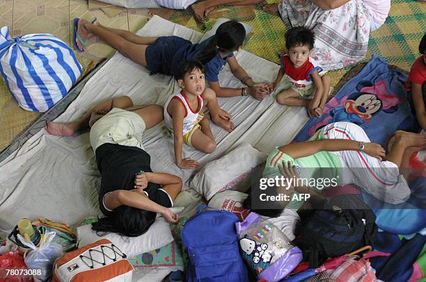 Evacuees from the village of Ilawod, in Guinobatan Albay province, Southeast of Manila, rest in an evacuation center, 23 November 2007. The weather...