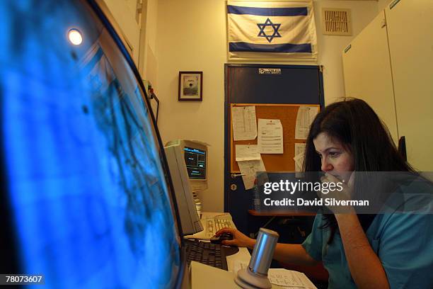 Israeli pediatric cardiologist Dr Alona Raucher-Sternfeld examines the catheterisation results on 2-year-old Iraqi girl Sozy Khalil after her surgery...