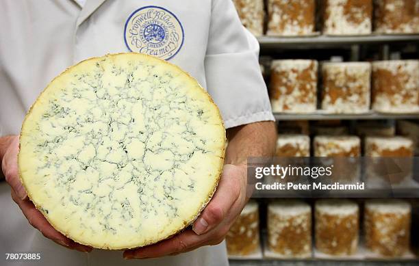 Howard Lucas, production manager, holds a Stilton cheese at the Cropwell Bishop Creamery on November 7, 2007 near Nottingham, England. Stilton cheese...