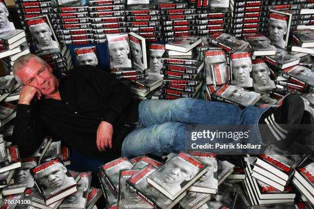 Former boxer star Graciano "Rocky" Rocchigiani poses between his new released book during a photosession to promote his new biography "My 15 rounds"...