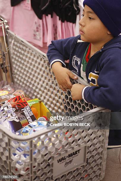 Young early morning shopper waits for his parents at a Wal-Mart store in Panorama City, California, 23 November 2007. The day after Thanksgiving,...