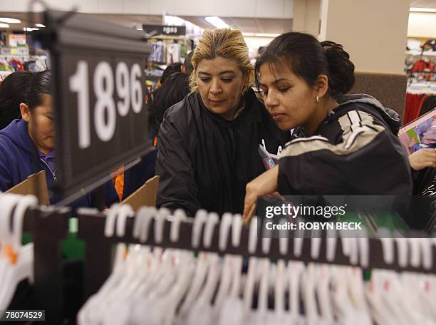 Early morning shoppers look through merchandise at a Wal-Mart store which opened its doors at 5:00am, in Panorama City, California, 23 November 2007....