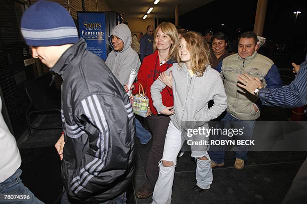 Early morning shoppers are encouraged not to run as the doors open at 5:00am at a Wal-Mart store, in Panorama City, California, 23 November 2007. The...