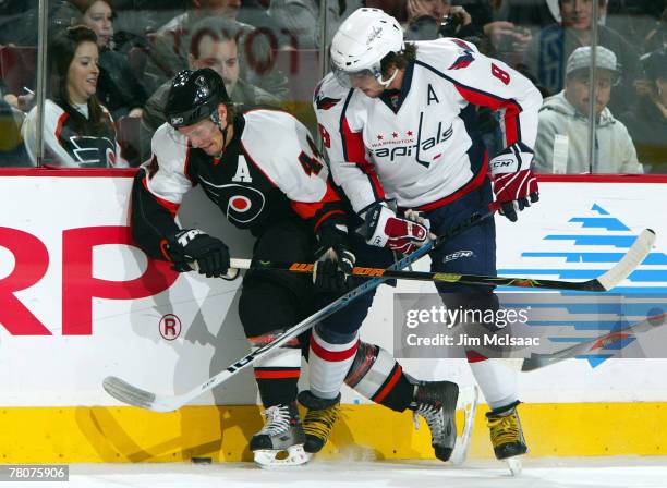 Alexander Ovechkin of the Washington Capitals battles for the puck against Kimmo Timonen of the Philadelphia Flyers during their game on November 23,...