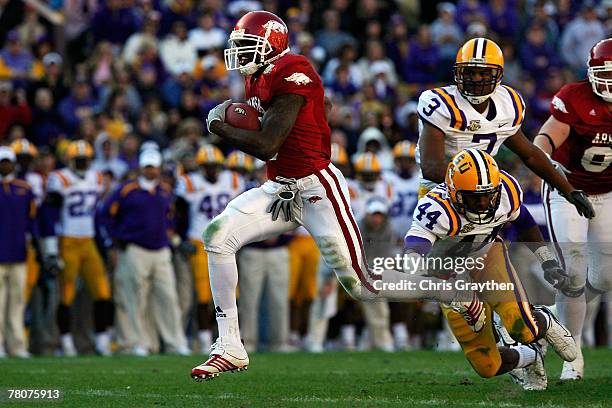 Darren McFadden of the Arkansas Razorbacks runs past Danny McCray of the Louisiana State University Tigers to score a touchdown on November 23, 2007...