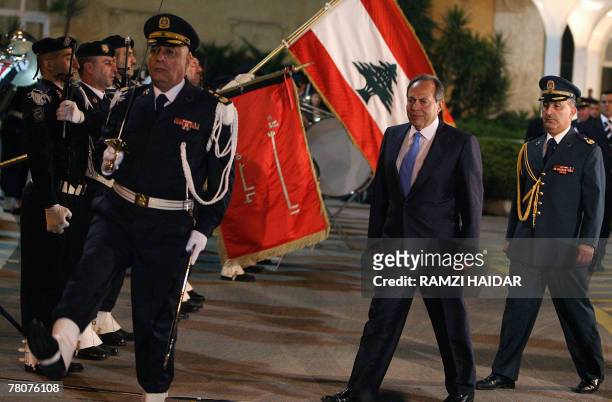 Outgoing Lebanese President Emile Lahoud makes the last review to his troops of honour before leaving the Presidential Palace in Baabda north of...