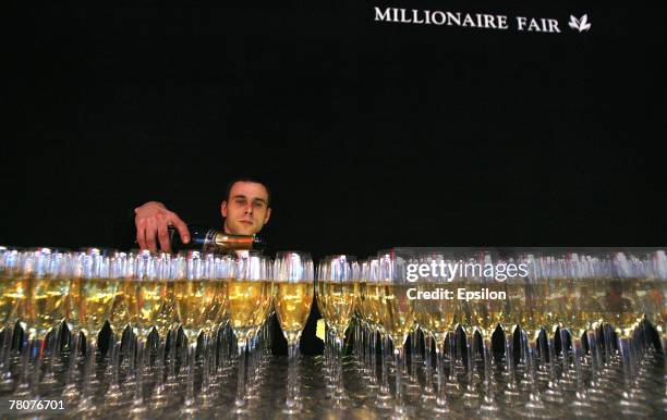Waiter serves drinks at the Millionaire Fair 2007 at Crocus Expo November 22, 2007 in Moscow, Russia. The Millionaire Fair, the world's largest...
