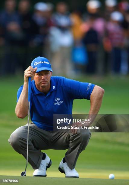Retief Goosen of South Africa lines up a putt on the 16th hole during the third round of the Omega Mission Hills World Cup at the Mission Hills Golf...