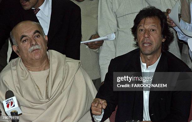 Leader of All Parties Democratic Movement Alliance Imran Khan is watched by Asfandyar Wali as he addresses a press conference in Islamabad, 24...