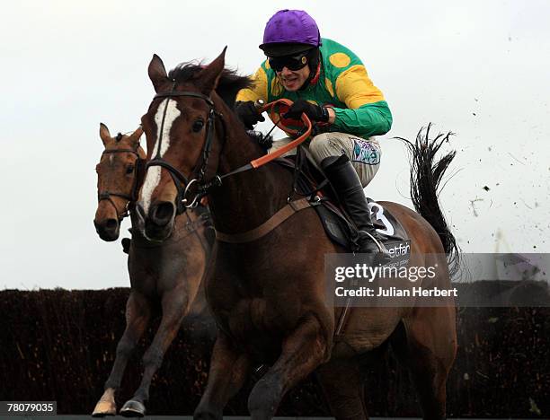 Sam Thomas and Kauto Star clear the last fence to land The Betfair Steeple Chase Race run at Haydock Racecourse on November 24 in Haydock, England.