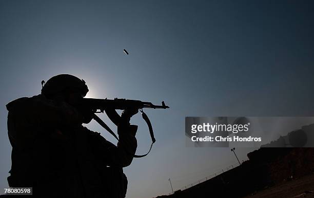 Member of the 2-69 Armored Battalion of the 3rd Infantry Division fires an AK-47 assault rifle during target practice November 24, 2007 in Baghdad,...
