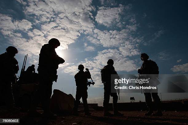 Members of the 2-69 Armored Battalion of the 3rd Infantry Division line up before engaging in rifle practice November 24, 2007 in Baghdad, Iraq. The...
