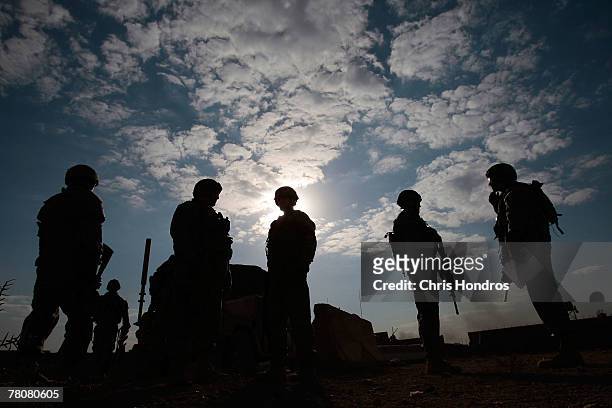 Members of the 2-69 Armored Battalion of the 3rd Infantry Division line up before engaging in rifle practice November 24, 2007 in Baghdad, Iraq. The...