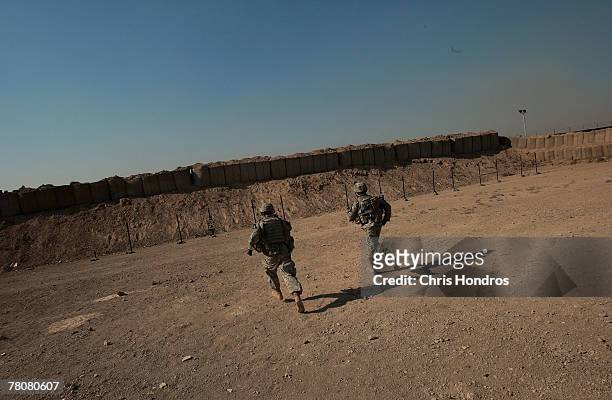 Members of the 2-69 Armored Battalion of the 3rd Infantry Division run to check out targets downrange during rifle practice November 24, 2007 in...