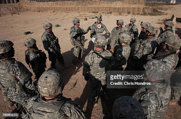 Members of the 2-69 Armored Battalion of the 3rd Infantry Division gather up for a safety briefing before engaging in rifle practice November 24,...