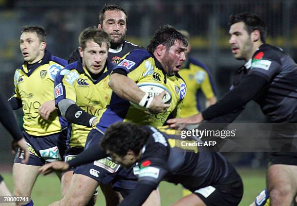 Clermont's prop Martin Scelzo breaks away from Albi's winger Regis Bianco and centre Thibault Lacroix during their French Top 14 rugby union match...