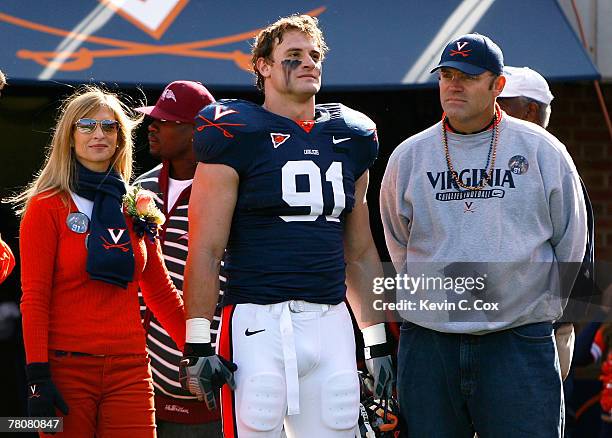 Defensive end Chris Long of the Virginia Cavaliers stands with his mother Diane and his father and Pro Football Hall of Famer Howie Long before...