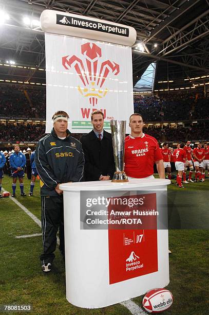 Prince William stands with the Prince William Cup and South Africa's Rugby Team captain John Smith and Wales' captain Gethin Jenkins prior to the...