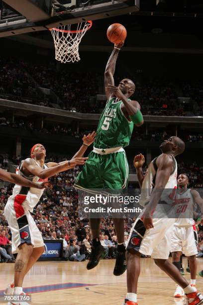 Kevin Garnett of the Boston Celtics dunks over Walter Hermann and Emeka Okafor of the Charlotte Bobcats during the game at the Charlotte Bobcats...